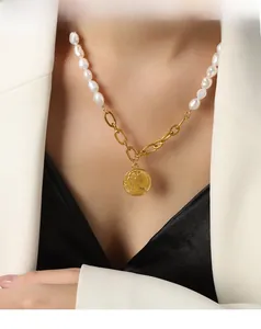 Detail of vintage freshwater pearl necklace with gold coin pendant and mixed chain link