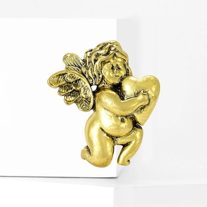 Vintage gold angel brooch with cupid holding a heart on a white minimalist background