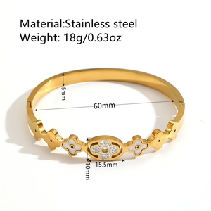 Gold stainless steel flower bangle with white shell clovers and sparkling crystals