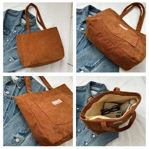 Detail view of brown corduroy tote bag showing interior lining and magnetic closure