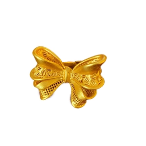 Gold bow open ring featuring intricate hollow mesh wings and a matte finish texture