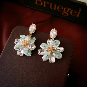 Elegant gold flower earrings with green crystal core and clear petal rhinestones