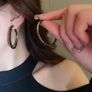 Chic oversized hoop earrings with pavé black zircons and dark gunmetal finish for women