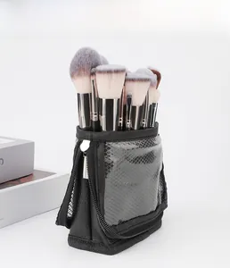Detailed view of makeup brushes with black leather and snakeskin mesh storage bag