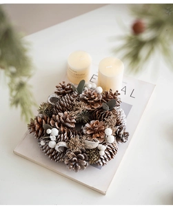 Detail of Christmas wreath with natural pine cones, white berries, and rustic winter foliage