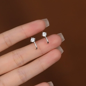 Elegant S925 sterling silver curved stud earrings with cubic zirconia on a dark background