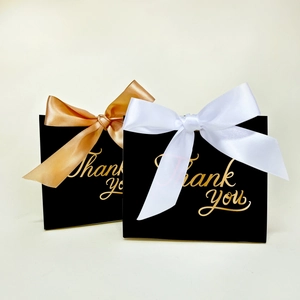 Elegant black European gift boxes with gold Thank You text and decorative silk ribbons