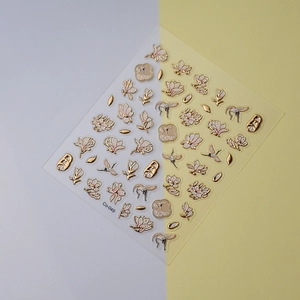 Macro detail of 5D embossed nail stickers featuring golden cranes and magnolia flowers