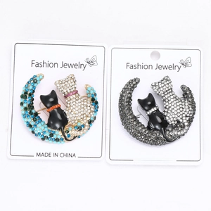 Detailed comparison of cat on the moon brooches in blue-gold and black-gray color options