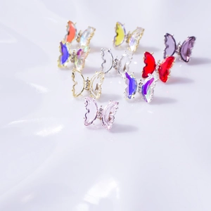 Rotating crystal butterfly nail art charms in multiple colors with sparkling accents