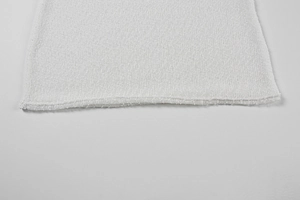Close-up of white knit fabric texture featuring seamless natural rolled edge finish