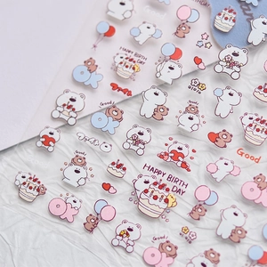 Macro shot of cute cartoon bear nail stickers with birthday balloons and party motifs