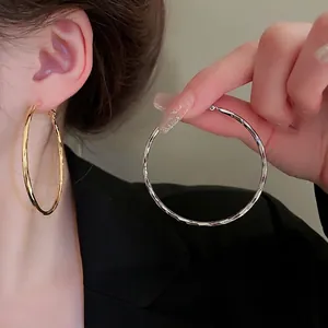 Polished gold and silver chunky hoop earrings with geometric hammered texture for women