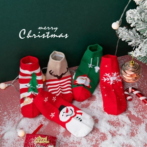 Five pairs of festive Christmas cotton socks with Santa and reindeer patterns for kids