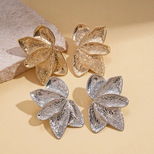 Textured metallic flower petal stud earrings in polished gold and silver finishes