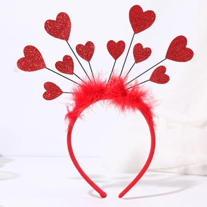 Detail of red sequin heart headband featuring vibrant glitter and soft feather trimming