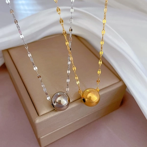 Minimalist gold and silver bead necklaces on white silk with flat sequin chain links