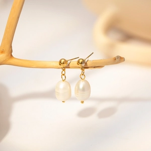 French vintage freshwater pearl drop earrings in 18k gold plating on a wooden branch