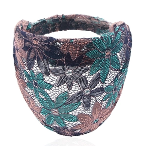 Macro shot of dark blue lace headband with green floral pattern and elastic band