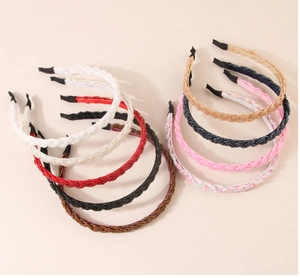 Macro display of assorted braided headbands in various colors with elegant fabric textures
