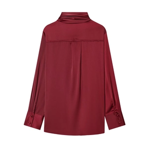 Detail view of burgundy satin shirt back with pleat and decorative cuff buttons