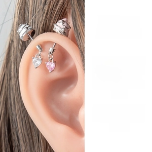 Detail of sweet ice cream heart ear stud set showing placement on earlobe and cartilage
