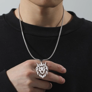 Silver lion head pendant necklace worn on a neck, highlighting hip-hop style metal texture