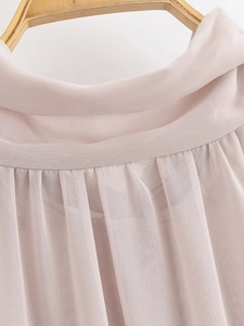 Close-up of pleated neckline details and sheer chiffon fabric texture in dusty rose