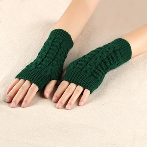 Detail of dark green cable knit fingerless gloves showing thick twist pattern texture