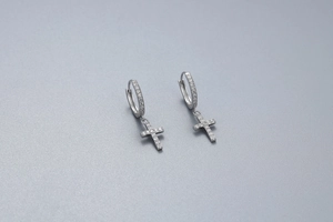 Detailed view of S925 sterling silver cross earrings with sparkling pavé cubic zirconia