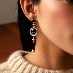 Vintage gold-plated drop earrings with black enamel circles and sparkling white stones