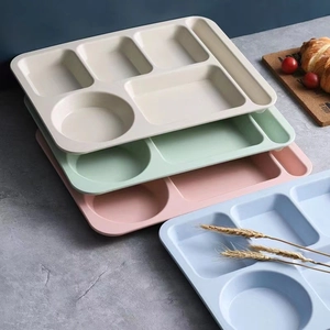 Eco-friendly wheat straw divided dinner plate set in four pastel colors on a textured table
