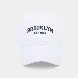 Detailed view of the Brooklyn EST 1631 embroidery on a white vintage cotton baseball cap