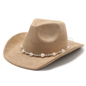 Macro detail of tan suede cowboy hat with white heart beads and silver metal band trim