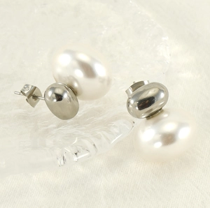 Macro shot of French vintage irregular pearl earrings with streamlined 18K gold-plated studs