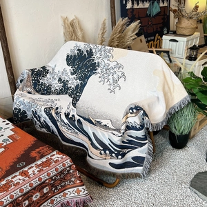 Detail of bohemian sofa throw blanket with wave pattern and decorative tassels for camping