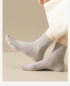 Close-up of light beige mid-calf cotton blend socks with a soft ribbed cuff design