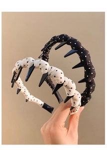 Detail of polka dot headband with inner plastic teeth for non-slip grip on hair