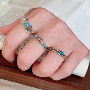 Detail of vintage bohemian ring set with turquoise stones and bronze engraving