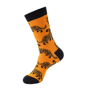 Detail view of cotton crew socks featuring orange tiger print and black contrast heel and toe