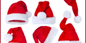 Detail view of five red plush Christmas hats with soft white faux fur trim and pom-poms