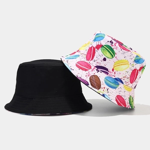 Detail of a black bucket hat and a white hat with colorful macaron print patterns