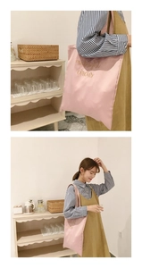 Detailed view of pink satin tote bag featuring elegant golden midnight circus embroidery