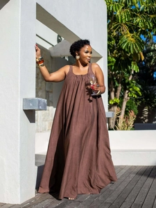 Detail of loose fit brown cotton maxi dress with sleeveless round neck design