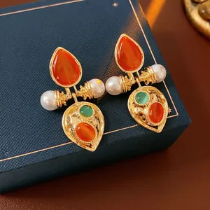Vintage palace style drop earrings with cat's eye gems and pearls on blue velvet box