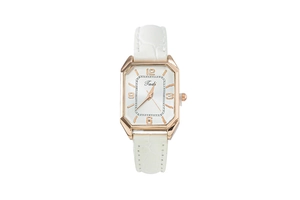 Detail of rectangular rose gold watch case with white leather strap and Tadi logo dial