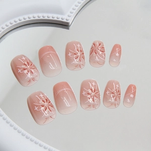 Short ballet press-on nails featuring blush pink gradient and fireworks star patterns