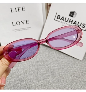 Close-up of retro cat eye sunglasses with purple translucent frame and tinted lenses