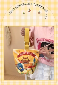 Detail of cute yellow canvas bucket bag with cartoon cat pilot print and soft handles