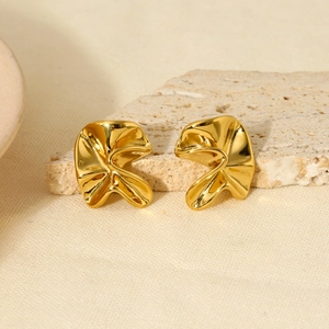 Golden irregular hammered texture 18k plated stainless steel stud earrings on stone